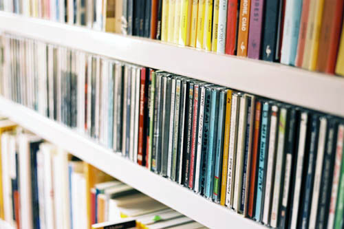 a private bookshelf with books and music