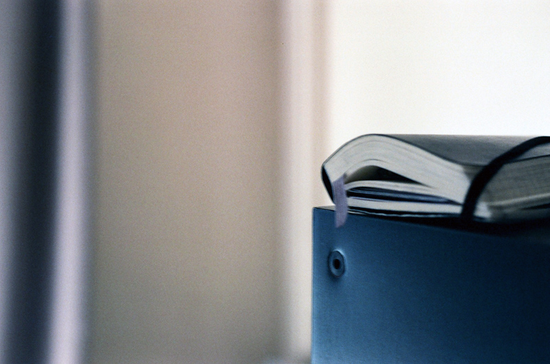 a moleskine on a bookshelf